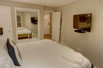 Master bedroom with king size bed, cable TV, and a closet