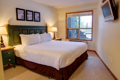 Bedroom with king bed and TV