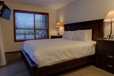 Bedroom with king bed and TV